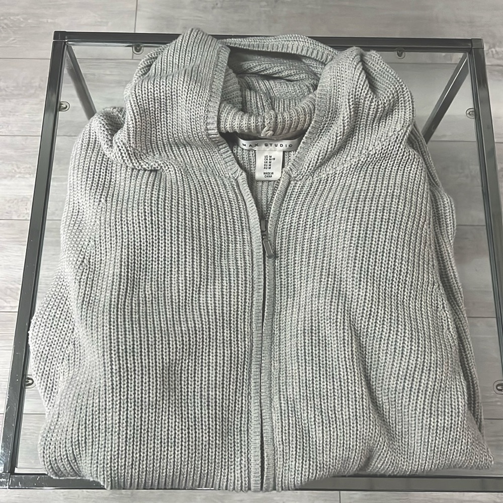 Women’s gray cotton sweater with zip front and hood. slant pocket at the hip